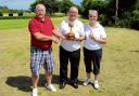 TROPHY TIME: Millers Barn’s Colin Bull makes the presentation  to Tom Murphy and back nine winner Doreen Brand.