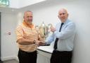 CUP KING: Alan Hearn receives the Canny Ryall Cup from Clacton Golf Club director Terry McConnell