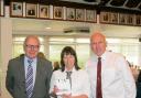 HELD IN HIGH REGARD: long-serving Sue Pisani receives her present from Clacton Golf Club chairman Bert Foster and chief executive Terry McConnell.