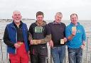 FESTIVE SUCCESS: the  winners of the Walton Pier Boxing Day competition. Pictured from left are Vic Pearce, Mark Peters, winner Richard Burt and Rob Tuck.