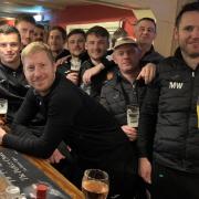 Cheers - Harwich and Parkeston's players and management, en route back to north Essex, stop off to celebrate their 1-0 victory at Hackney Wick