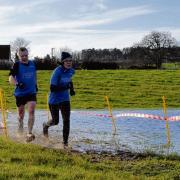 TACKLING THE COURSE: Great Bentley Running Club’s (from left in blue vests) Sue Sorrell, Harvey Lyon, Martin West and Davina Swindell compete in the 53-12 Cross-Contry League.
