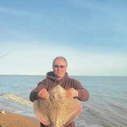 EYE-CATCHING: Neil Cocks with a nicely-marked thornback ray caught from St Osyth beach.