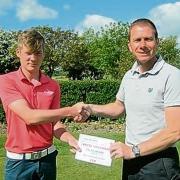 GREAT PERFORMANCE: Max Smith is congratulated by Clacton head professional Michael Goodwin after winning the best individual score in the Faldo Wedge.