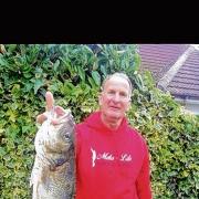 GREAT CATCH: Walton angler Doug Sadler with the bass he caught from Hipkins beach, at the Naze.
