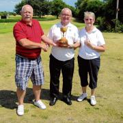 TROPHY TIME: Millers Barn’s Colin Bull makes the presentation  to Tom Murphy and back nine winner Doreen Brand.