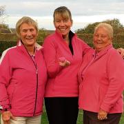 PINK DAY: Di Kedge, left, and Lyn Willson, right, were lady captain Julia Hewett’s playing partners in the three-person team game.