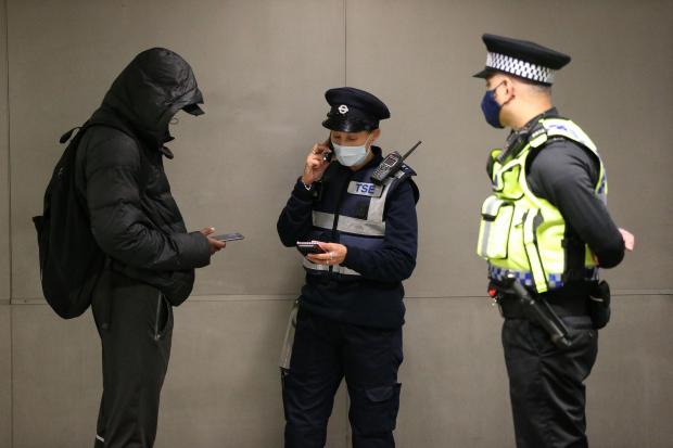 Clacton and Frinton Gazette: Warning - a man is issued with a fine for not wearing a facemask. Picture: PA Wire