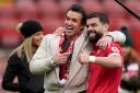 Wrexham co-chairman Rob McElhenney (left) and Wrexham's Elliot Lee celebrate on the pitch after the Sky Bet League Two match at the SToK Cae Ras, Wrexham. Picture date: Saturday April 27, 2024. PA Photo. See PA story SOCCER Wrexham. Photo credit