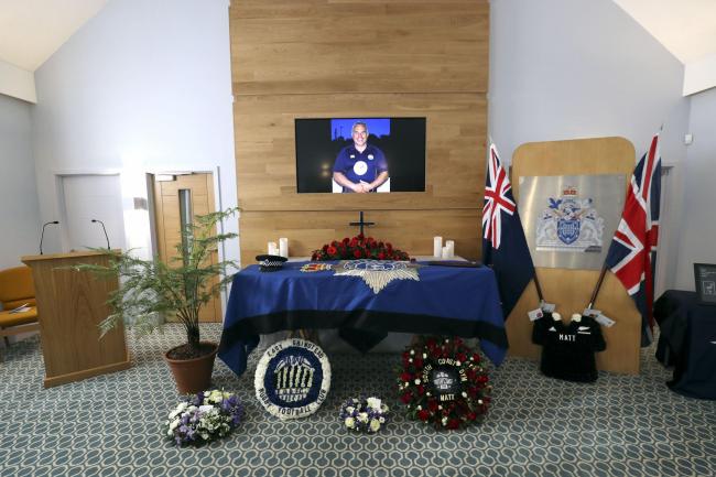 The coffin and floral tributes in the church before the funeral service of police officer Sergeant Matt Ratana