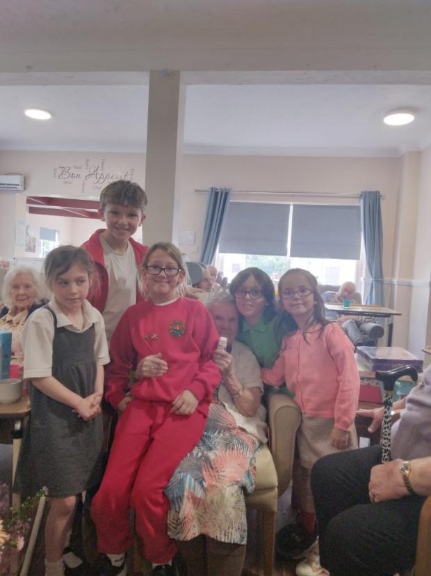 Clacton and Frinton Gazette: Adorable - Millie with pupils from Frinton Primary School