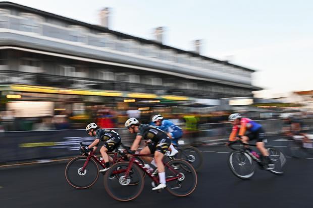 Race - cyclists fly past the Moon and Starfish during the event