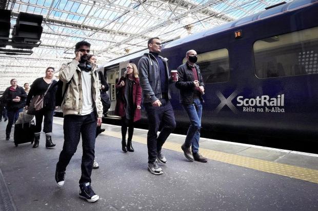 Commuters and a ScotRail train
