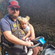 Cuddle - Nathan O'Leary and daughter Havana on his mobility scooter