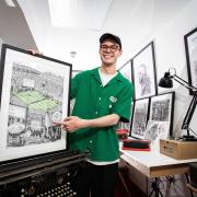 James Cook surrounded in his impressive collection of typewriters at his studio in Canning Town, East London.