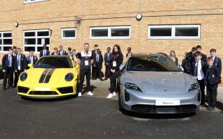 Former Clacton County High School students and current Porsche employees Joe Buckmann and Taryn Barella, let students take a peek inside the luxury cars